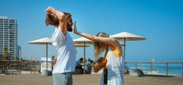 Girl jokingly stops her long-haired man.