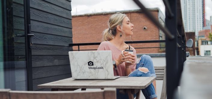 Woman drinking a coffee while looking outside