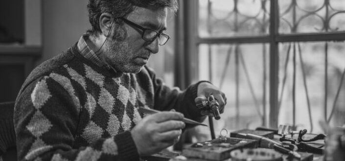 man doing handiwork in black and white 