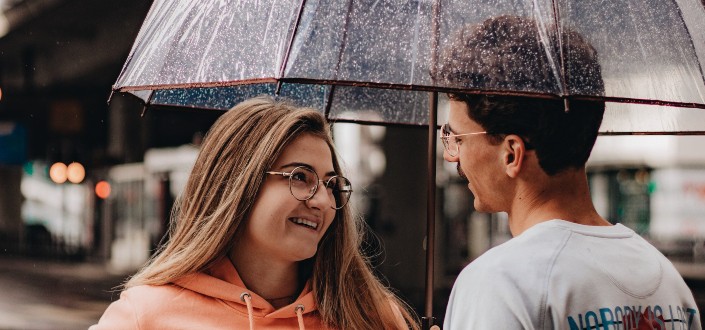 couple talking under umbrella