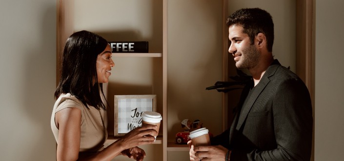 man and woman talking in their formal attire