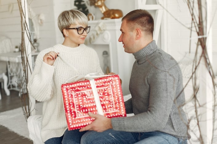 man giving gift to his woman