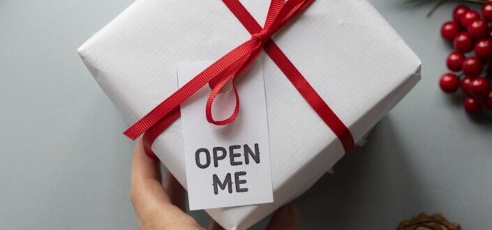 crop-faceless-woman-holding-christmas-gift-box-