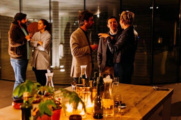 group of officemates talking in a party