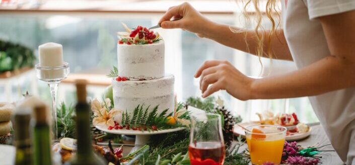 crop-woman-chef-decorating-cake-