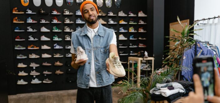 man-holding-a-pair-of-rubber-shoes-