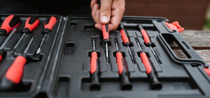 faceless-master-choosing-screwdriver-from-toolbox-