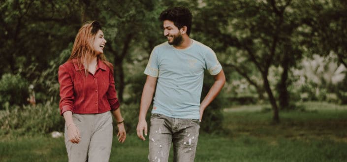 Man and women laughing while walking