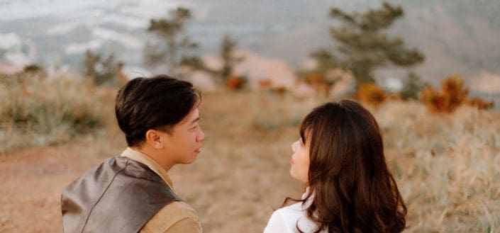 Man and woman talking while in a field