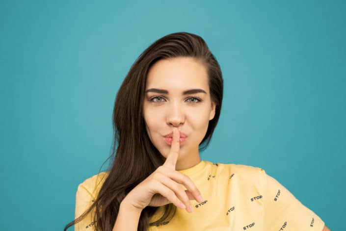A woman with her finger on her lips