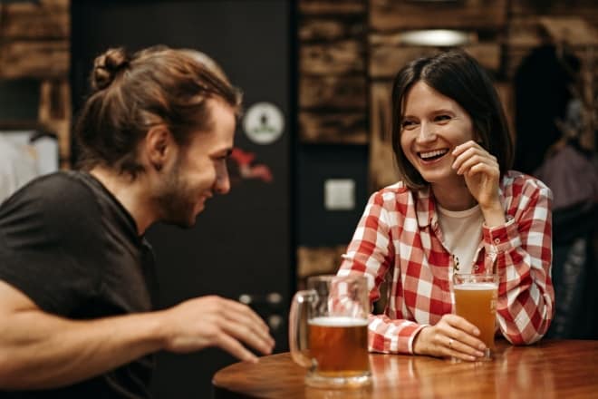 Man and Woman Sitting at Table - Personal questions to ask to get to know someone 