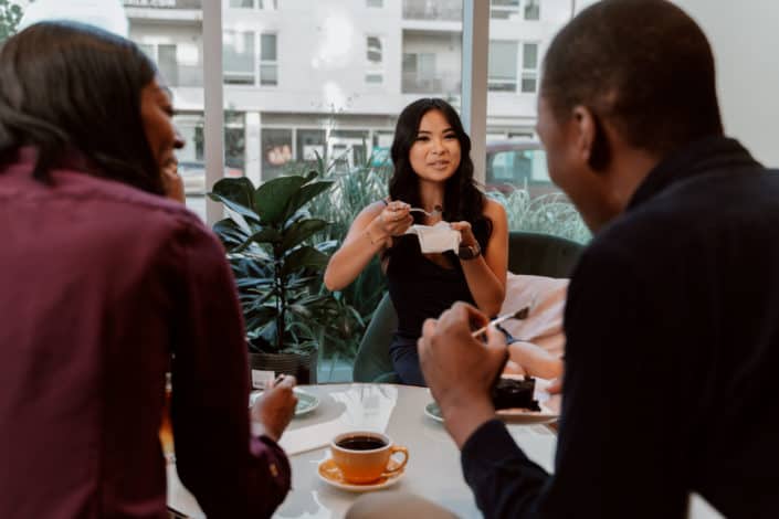 Three people drinking coffee together