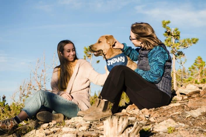 Two women sitting with a dog