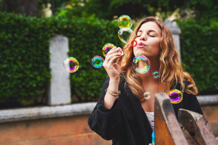 Woman blowing bubbles