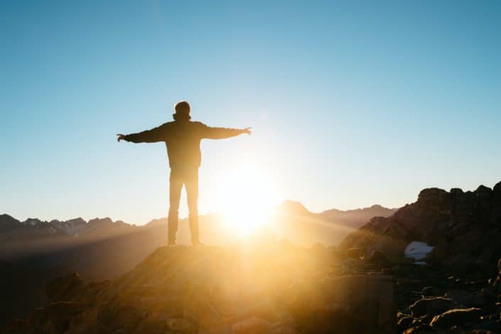Man standing on top of a mountain