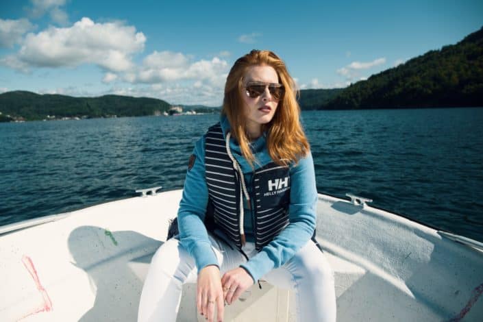 Woman sitting on a boat in the middle of the sea