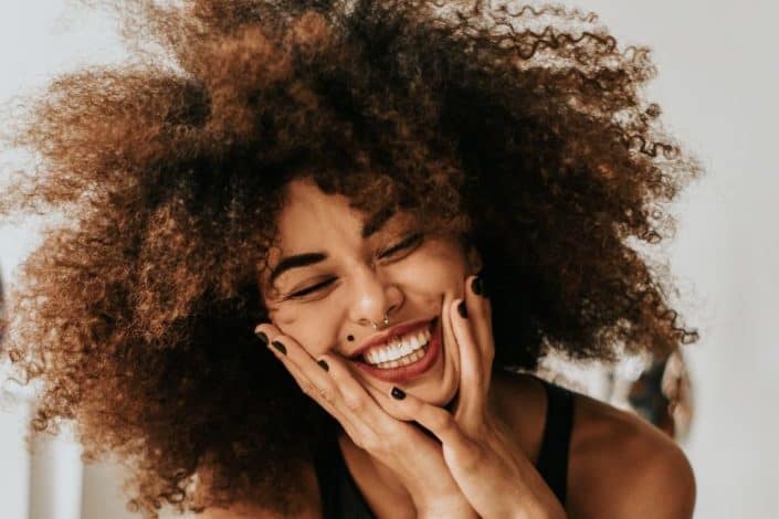 Woman Sitting And Smiling
