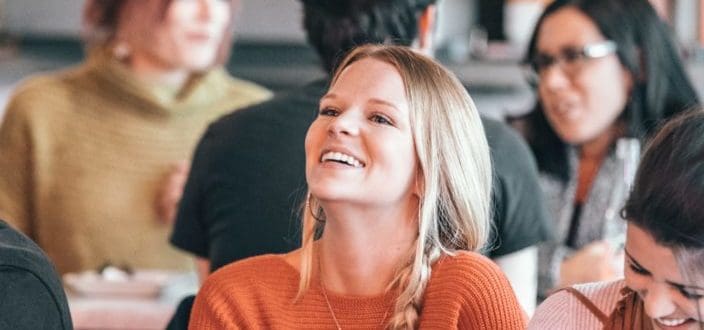 woman smiling brightly while looking upfront