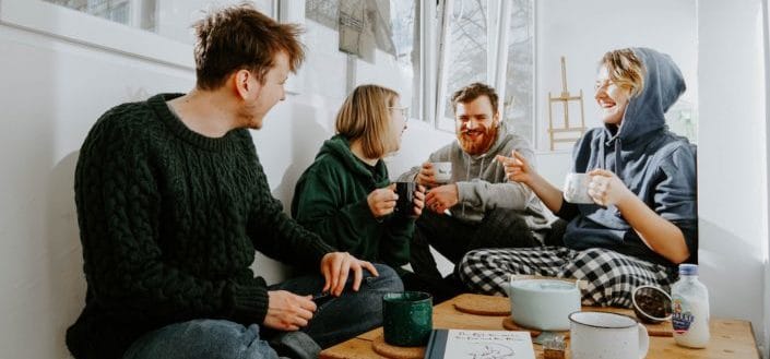 group of friends eating breakfast happily