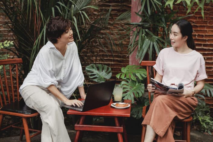 Two friends talking while working