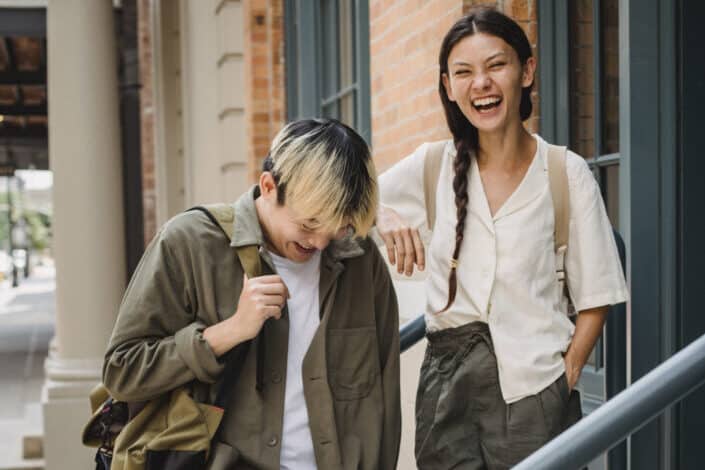 A couple laughing on a staircase