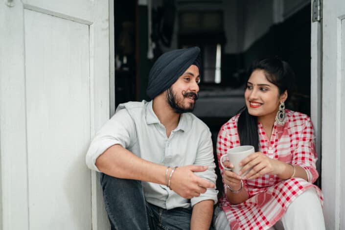 A couple talking while sitting in a doorway