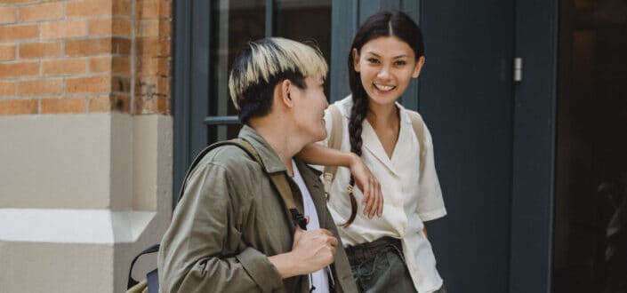 A woman with her arm on her friend's shoulder