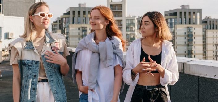 Three girls walking and smiling