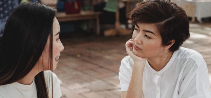 Two women talking seriously