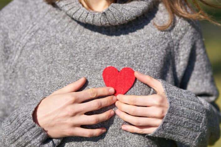 Woman Holding Heart Cut Out