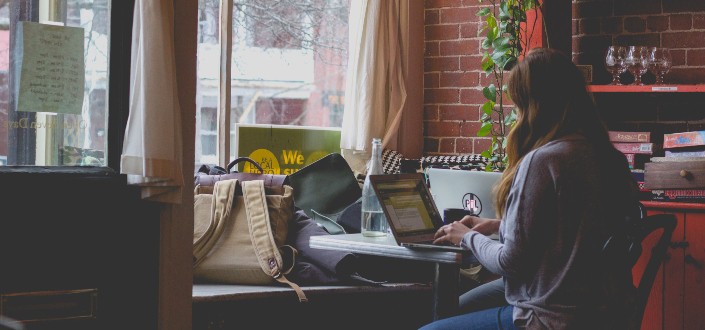 Woman Working on Her Laptop in a Cafe