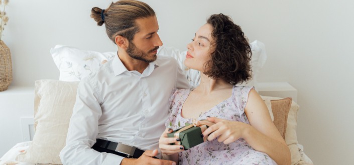 Man and woman sitting on couch