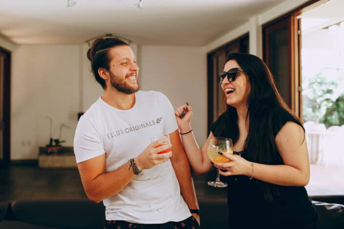 Couple having fun with drinks on hand. 