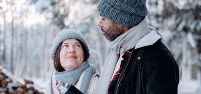 a couple in winter suits, lovingly talking
