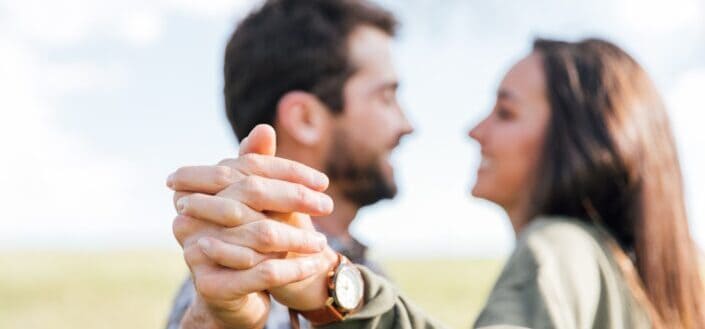 Couple, holding hands, staring at each other