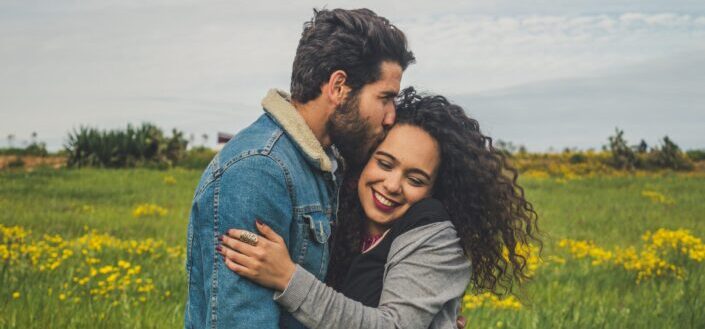 a guy passionately kisses a girl's head