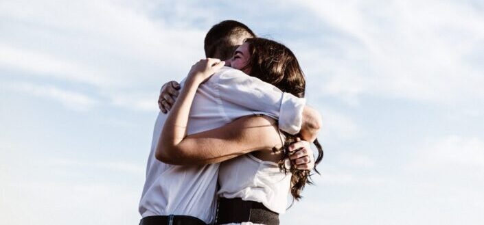 Couple hugging wearing white