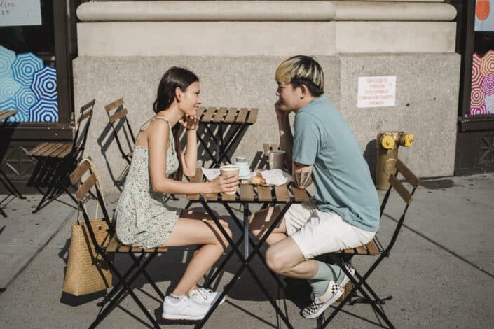 Couple having coffee outdoors.