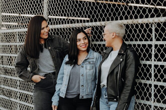 questions to ask your friends - three friends talking to each other while smiling