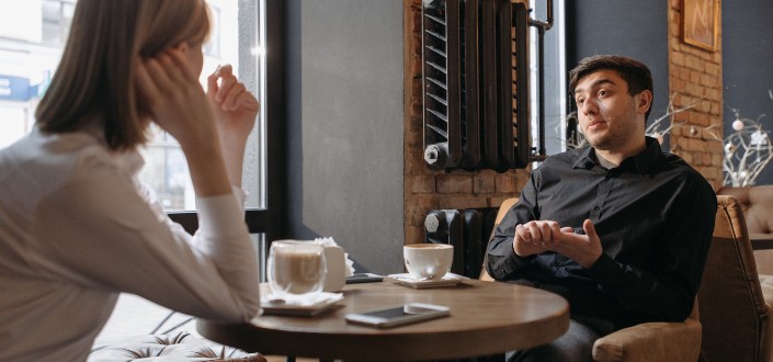 Two People Discussing Inside a Coffee Shop