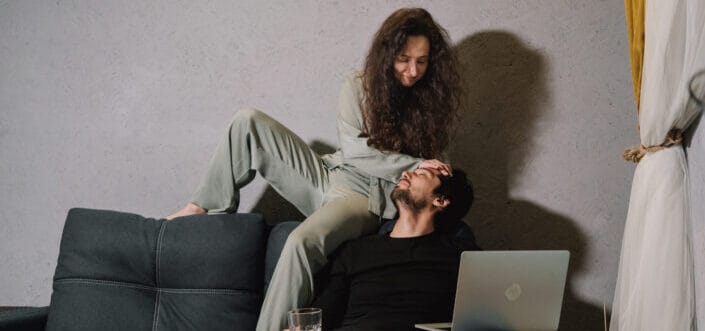  woman calming his man at the sofa