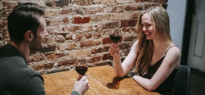couple enjoying date in restaurant with wineglass
