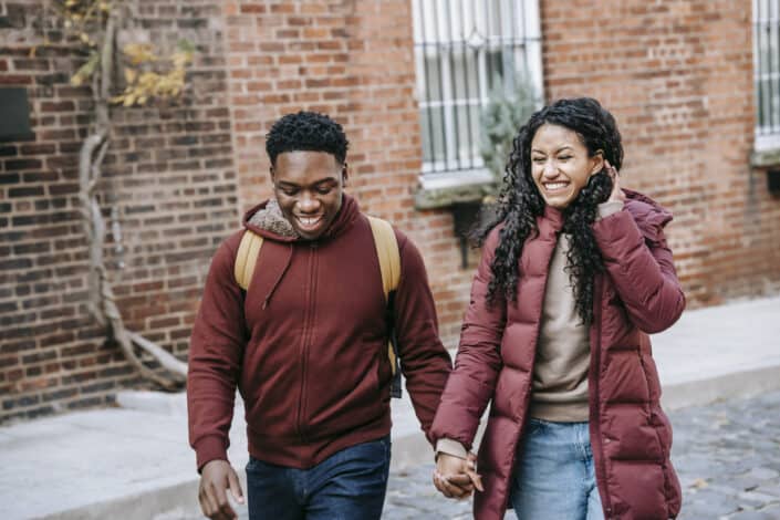happy couple holding hands while walking