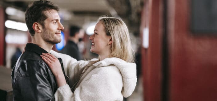 happy couple hugging in underground passage