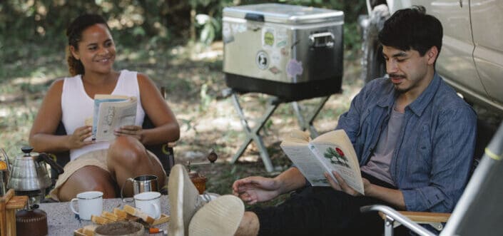 couple reading novels during camping