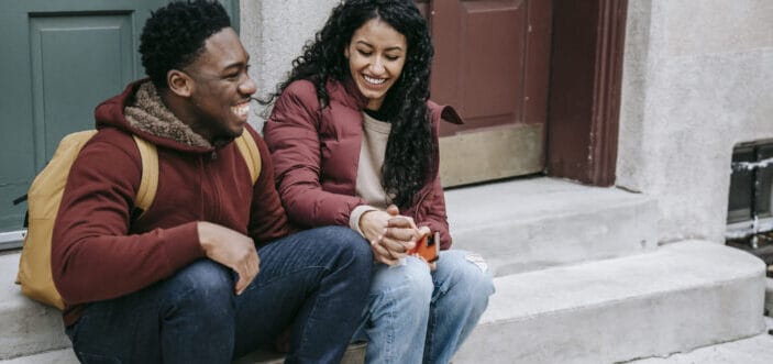 happy couple holding hands on stairs