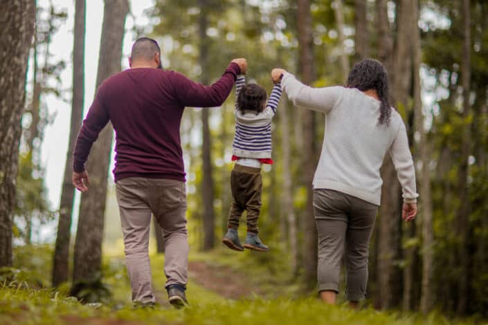 Man and woman carrying toddler