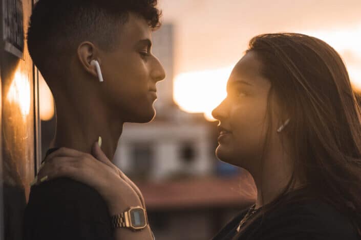 man and woman hugging under sunset