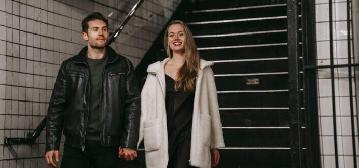  positive couple going downstairs in underground passage