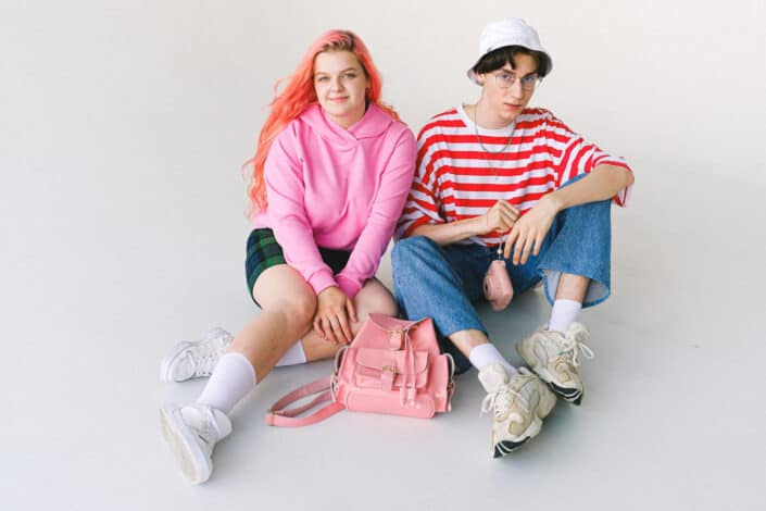 stylish teenage couple in vivid clothes